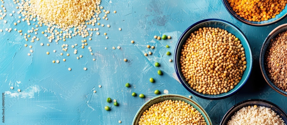 Fototapete various cereals like buckwheat lentils rice and peas presented on plates with a blue background in a