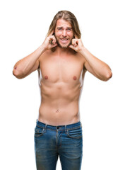 Young handsome shirtless man with long hair showing sexy body over isolated background covering ears with fingers with annoyed expression for the noise of loud music. Deaf concept.