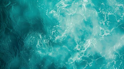 Obraz premium Sea surface in a turquoise lagoon, top view. The texture of sea water. Transparent turquoise sea water, natural background. Summer and travel vacation concept.