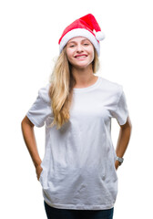 Young beautiful blonde woman wearing christmas hat over isolated background with a happy and cool smile on face. Lucky person.