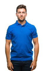 Fototapeta premium Young handsome man over isolated background with serious expression on face. Simple and natural looking at the camera.