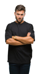 Fototapeta premium Young handsome man over isolated background skeptic and nervous, disapproving expression on face with crossed arms. Negative person.