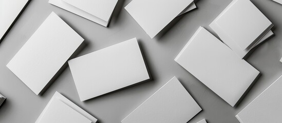 Fototapeta premium Grey background with blank business cards featuring copy space image