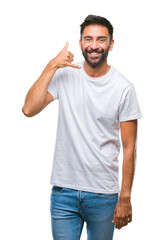 Fototapeta premium Adult hispanic man over isolated background smiling doing phone gesture with hand and fingers like talking on the telephone. Communicating concepts.