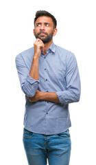 Adult hispanic man over isolated background with hand on chin thinking about question, pensive...