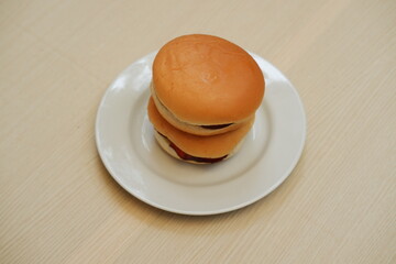 Hamburger bun on a white plate. Close up. top view
