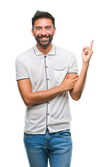 Adult hispanic man over isolated background with a big smile on face, pointing with hand and finger to the side looking at the camera.