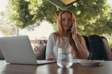Woman in cafe with a smartphone