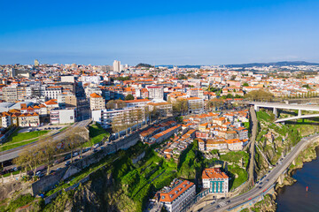 Obraz premium Famous historic Portuguese town of Porto, flying aerial view of roofs and houses of downtown Porto