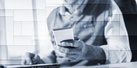 Senior businessman reading a message on his mobile phone, hard light, geometric pattern
