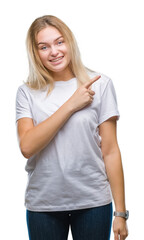 Fototapeta premium Young caucasian woman over isolated background cheerful with a smile of face pointing with hand and finger up to the side with happy and natural expression on face looking at the camera.