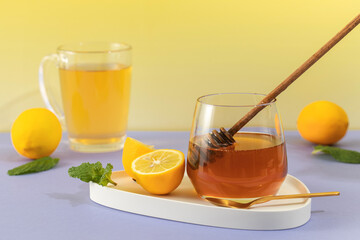 A natural remedy for colds and flu to boost immunity. A glass of tea, honey and lemon. 