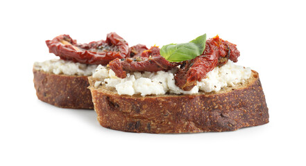 Delicious ricotta bruschettas with sun dried tomatoes and basil isolated on white