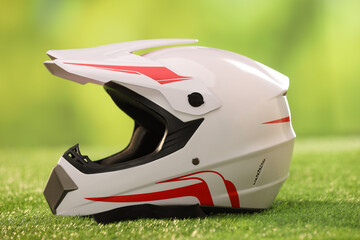 Modern motorcycle helmet with visor on green grass