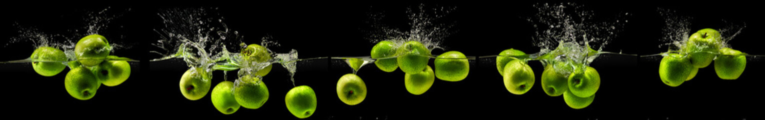 Green apple falling in water on black background