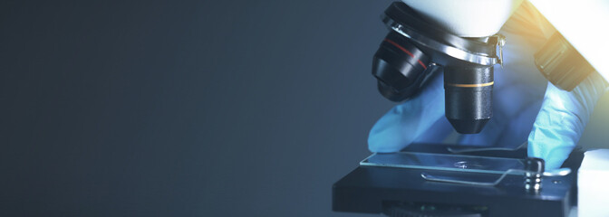 Microscope on dark background, closeup. Banner design with space for text