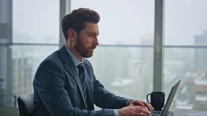 Man manager corresponding client using laptop office closeup. Guy taking notes