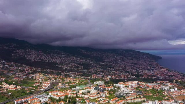 Funchal City and Mountains on Cloudy Day. Pico dos Barcelos Viewpoint. Madeira, Portugal. Aerial Drone Shot. Orbiting