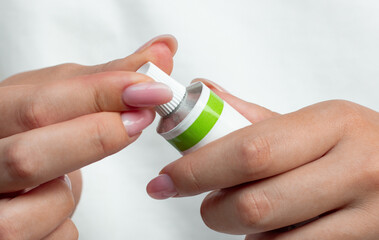 Woman holding ointment tube in her hands, closeup