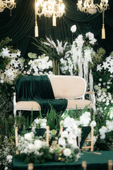 Elegant wedding decoration with a floral plant theme that is very lush like a forest. with a very romantic black background