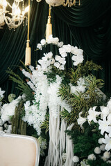 Elegant wedding decoration with a floral plant theme that is very lush like a forest. with a very romantic black background