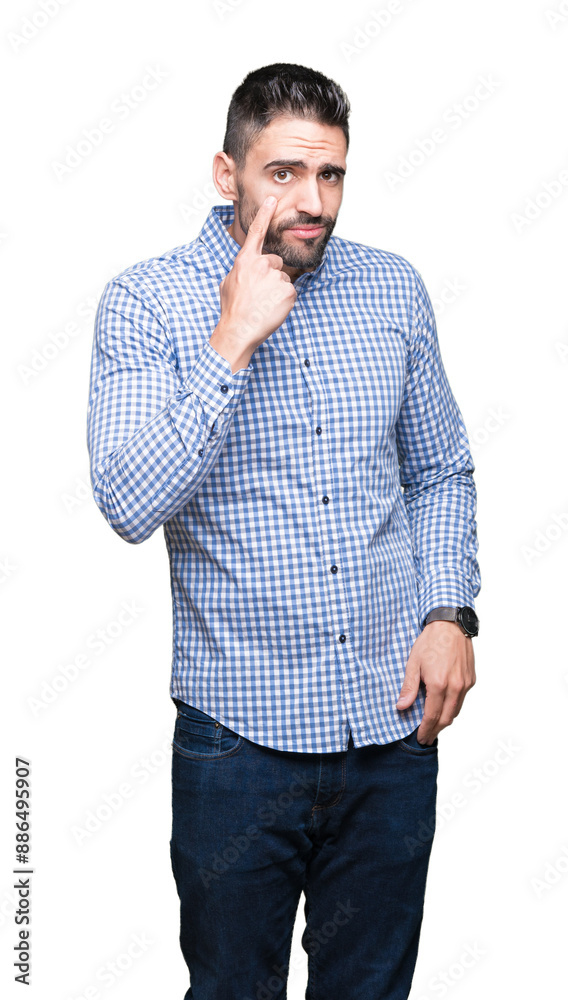 Sticker young handsome man over isolated background pointing to the eye watching you gesture, suspicious exp