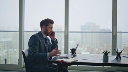 Fototapeta premium Disgruntled manager calling phone feeling stress at corporate office closeup