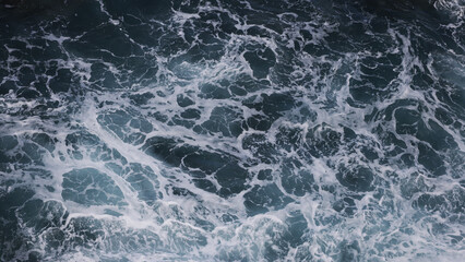 Abstract background. Waves of sea water meet underwater rocks, whirlpool