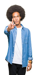 Young african american man with afro hair Pointing with finger up and angry expression