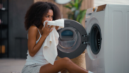 African American female woman girl ethnic lady housewife homeowner housework at floor open washing...