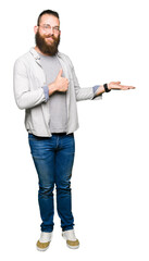 Young blond man wearing glasses Showing palm hand and doing ok gesture with thumbs up, smiling happy and cheerful