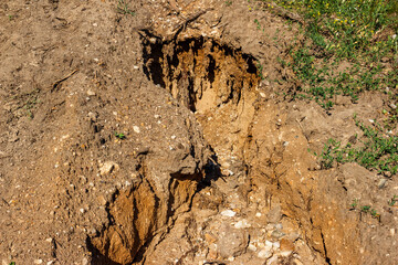 Rain erosion of sandy soil on a slope
