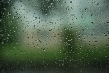 Window glass with water drops, closeup. Rainy weather