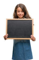 Brunette hispanic girl holding blackboard with a happy face standing and smiling with a confident smile showing teeth