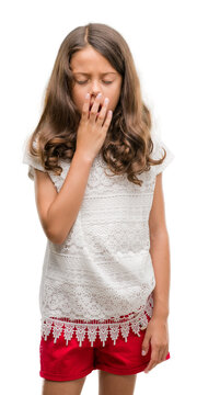 Brunette hispanic girl bored yawning tired covering mouth with hand. Restless and sleepiness.