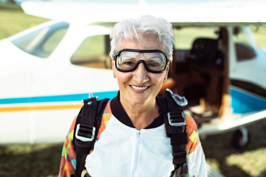 Portrait of a smiling senior woman ready to skydive
