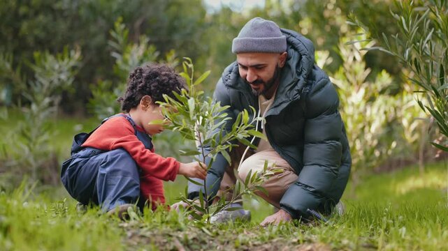 A heartwarming moment as a father teaches his young child to plant a seedling in the family garden, showcasing bonding and education.