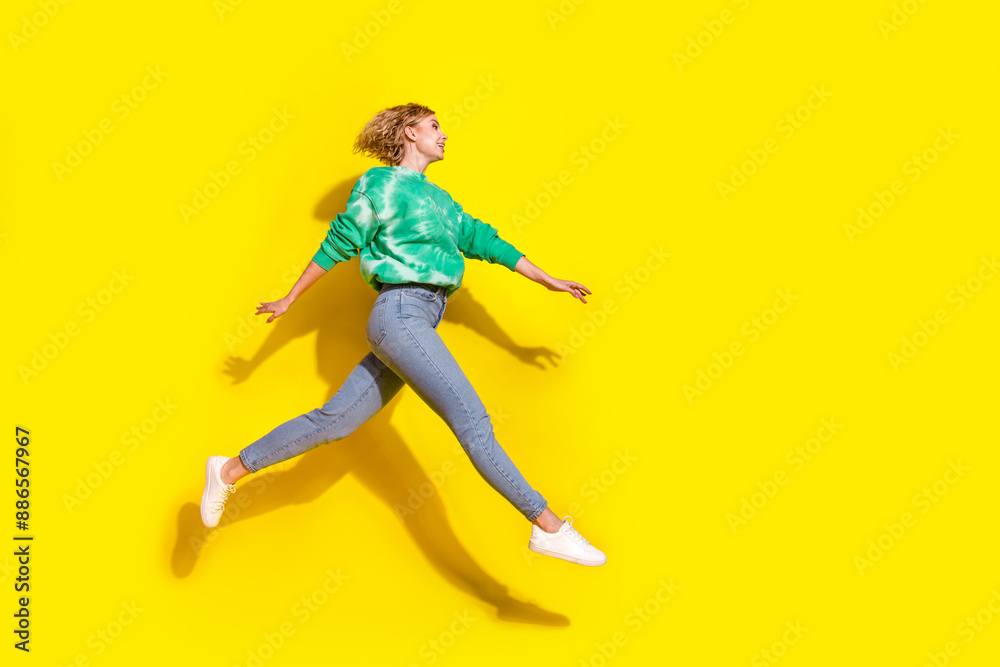 Canvas Prints Full length photo of shiny attractive lady dressed tie dye sweatshirt jumping high walking empty space isolated yellow color background