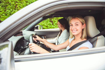 driver courses and people concept a car driving school instructor teaching young woman to drive