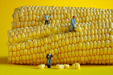 mini figures harvesting corn in a yellow setting