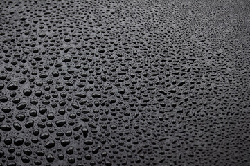 Clear side view of water drops after raining day on dark cover background