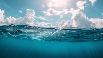 Blue sea or ocean water surface and underwater with sunny and cloudy sky