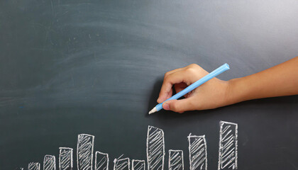 female hand against blank chalk board background in banner format with copyspace