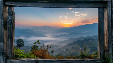 Obraz premium Wooden frame and beautiful mountains with fog in morning 