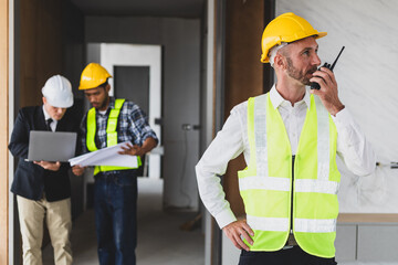 Businessman, contractors and engineers working at construction sites are construction inspector and supervise the work according to plans. Coworker cooperation and teamwork to ensure workplace safety.