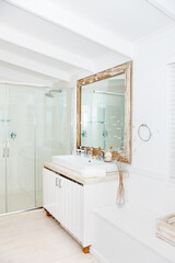 Luxury, mirror and shower in the bathroom interior of a modern home or apartment for lifestyle. Hotel, real estate or wealth with marble, ceramic tiles and a vanity against a wall for design