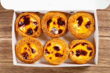 top view portuguese egg tarts in a box at horizontal composition