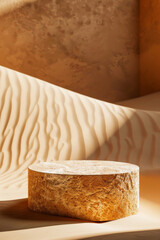 Smooth sandstone stone podium for product presentation on a warm, desert-themed background with sunlit dunes