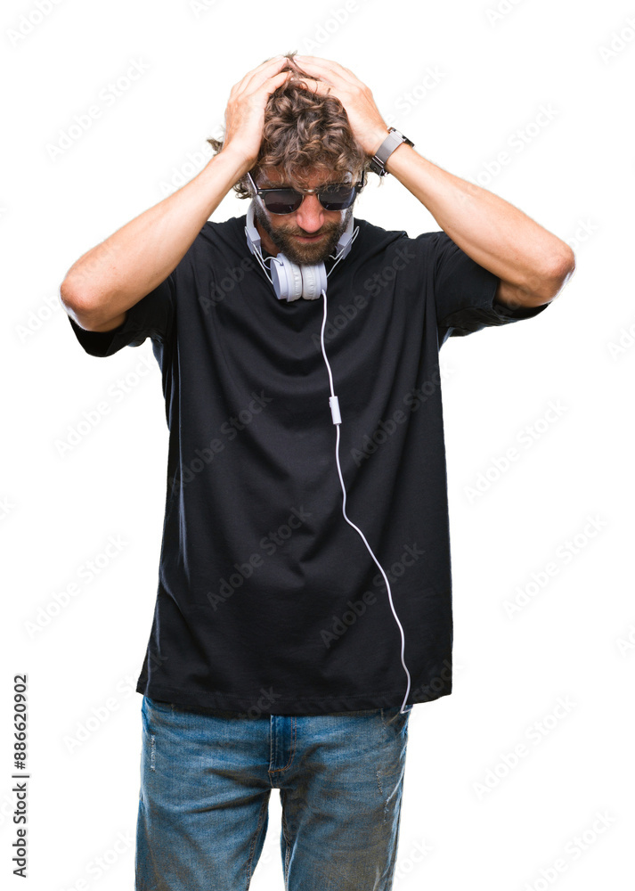 Poster handsome hispanic man listening to music wearing headphones over isolated background suffering from 