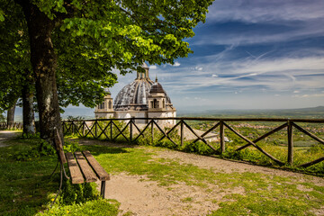 A glimpse of the ancient medieval village of Montefiascone, Viterbo, Italy. The Cathedral of Santa Margherita, with its dome and bell towers. A bench in the park, from where you can admire the view.